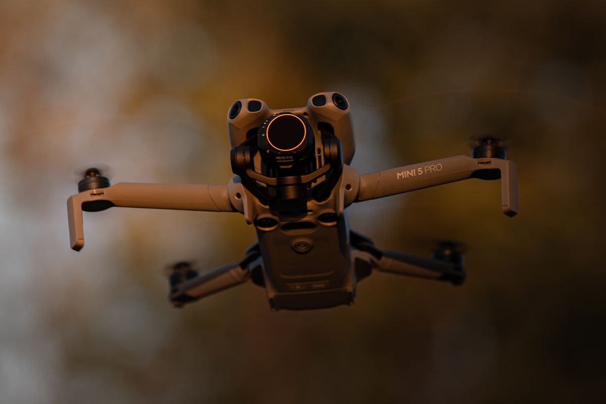 Aerial drone holding a steady hover against an Ontario treeline in low evening light
