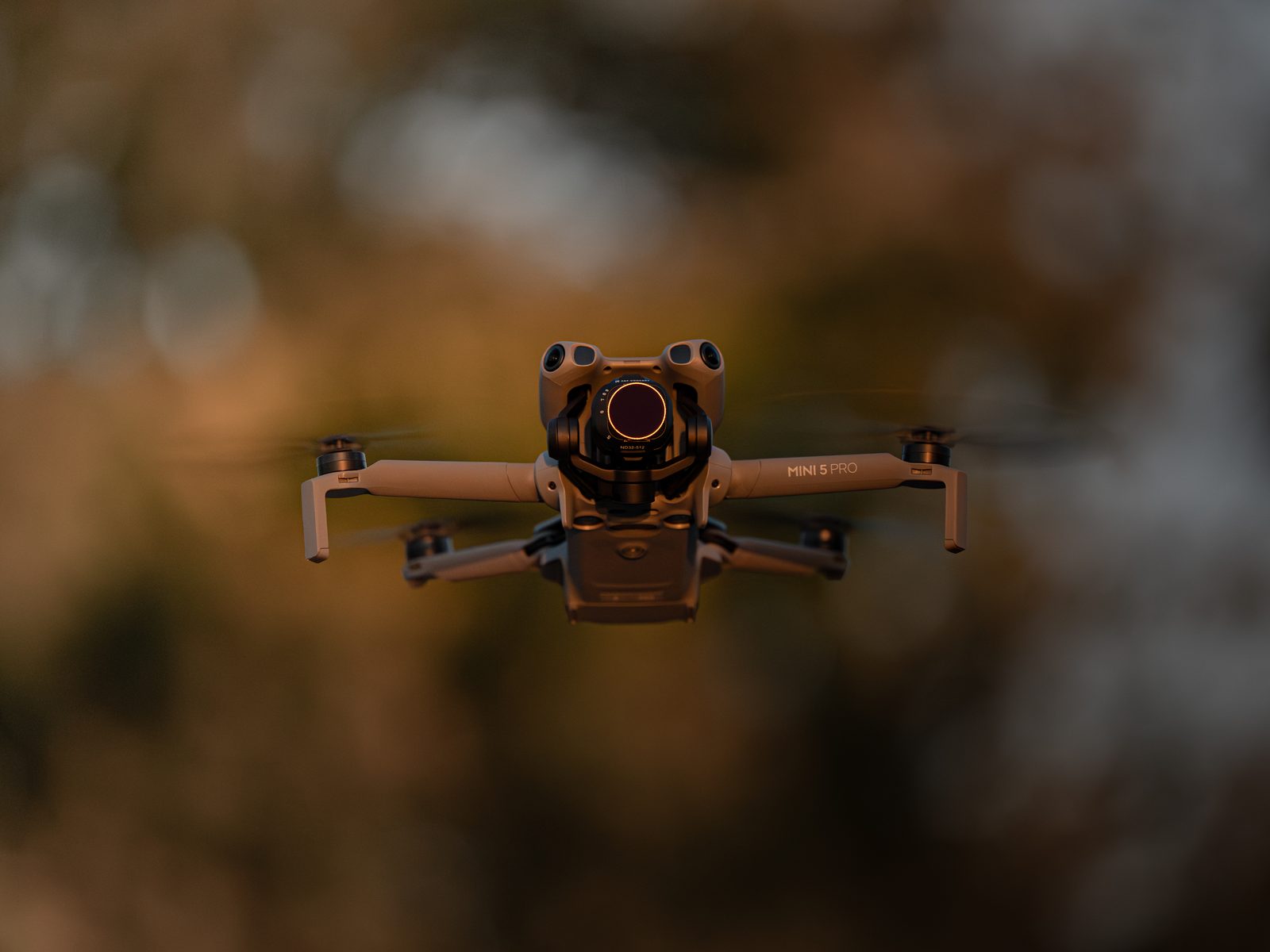 DJI Mini 5 Pro drone hovering at golden hour over Southern Ontario farmland